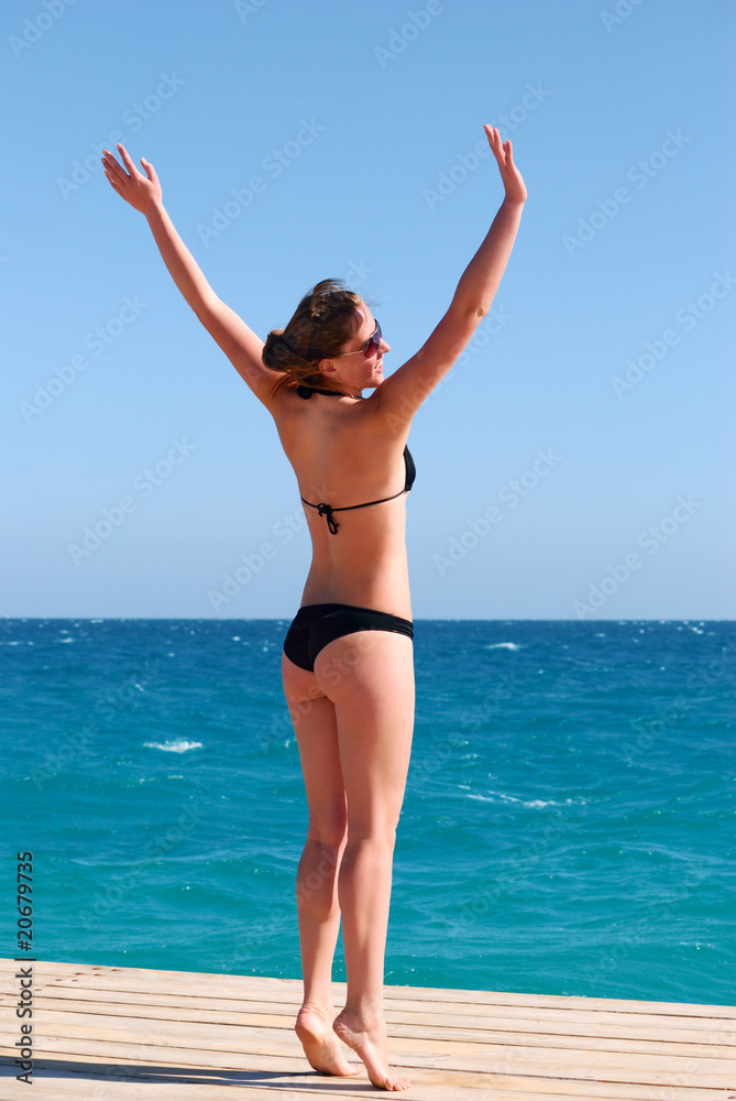 beautiful woman enjoying the sun near the sea beautiful woman enjoying the sun near the sea