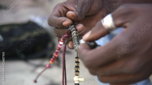 Black Muslim holding a rosary