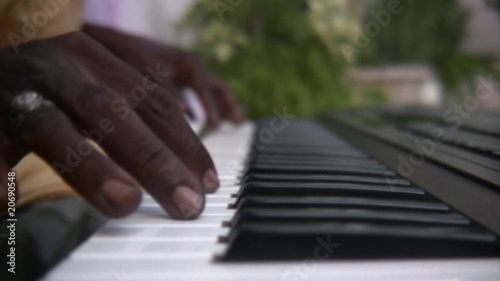 Black man playing the keyboard piano