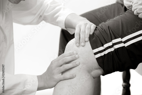 physical therapist checks a knee photo