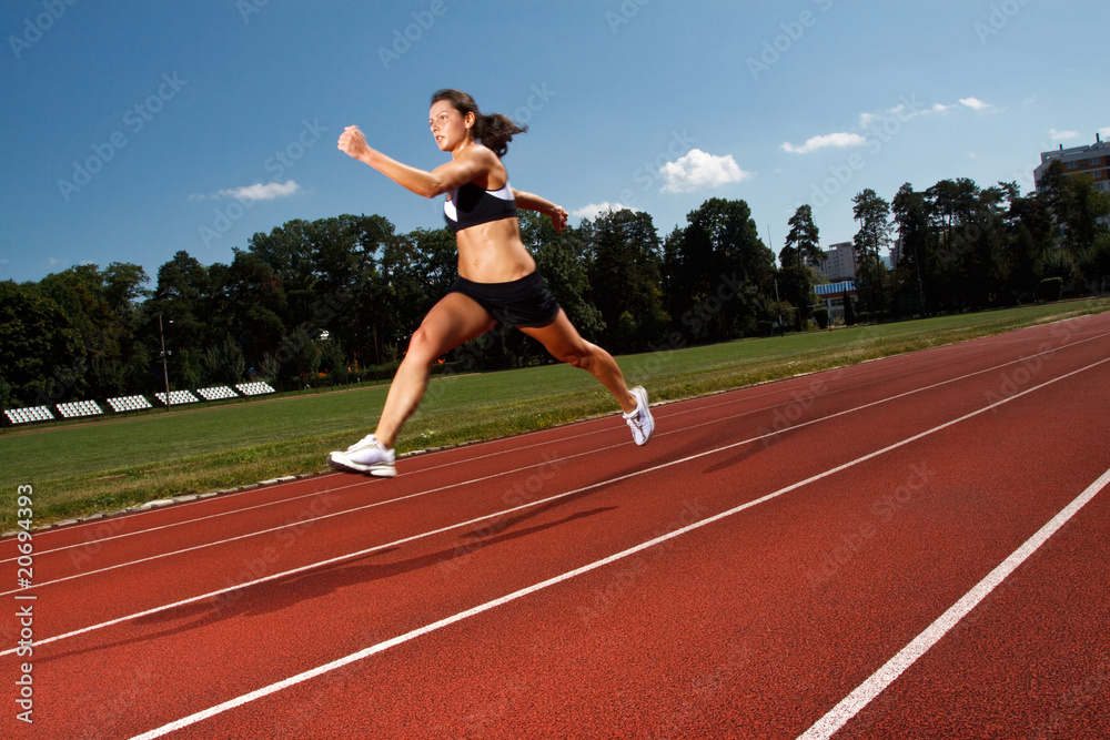 dynamic image of a young woman running on a track