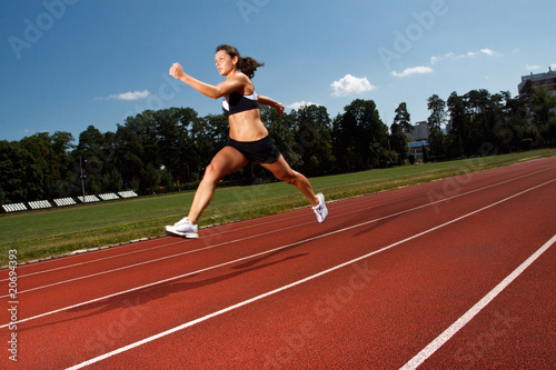 dynamic image of a young woman running on a track