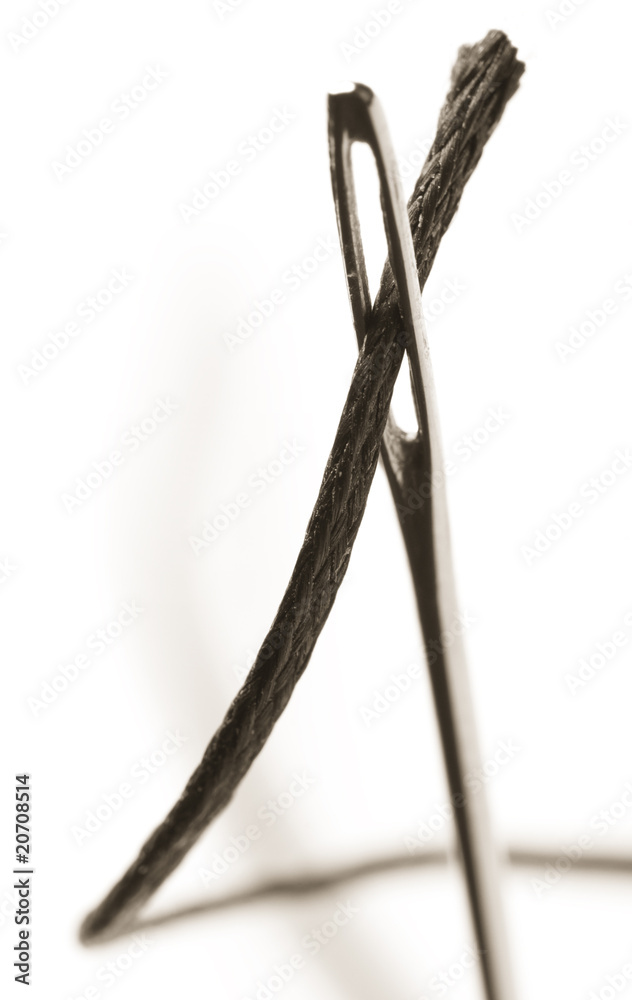 Needle with thread on white background