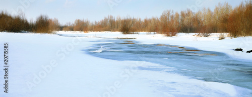 Frozen river. Melt in spring - threat of the flood. Natural disaster