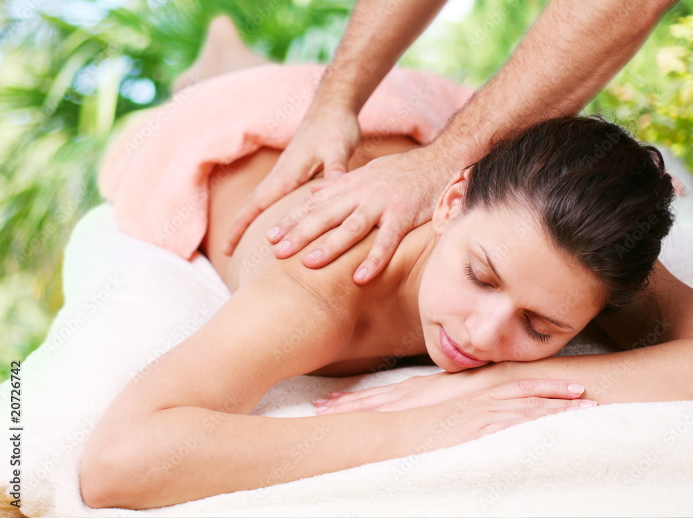 Young woman gets a massage. Eyes are closed. Young woman gets a massage. Eyes are closed.