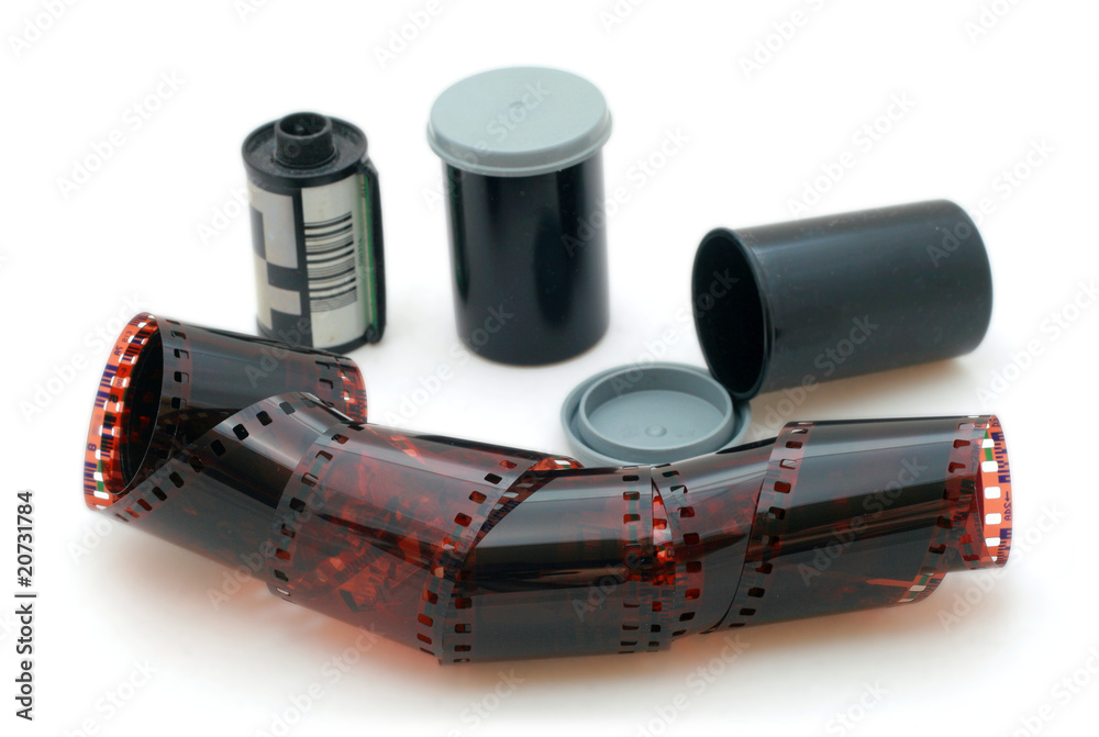 35 mm negative film and canisters isolated in white background Stock