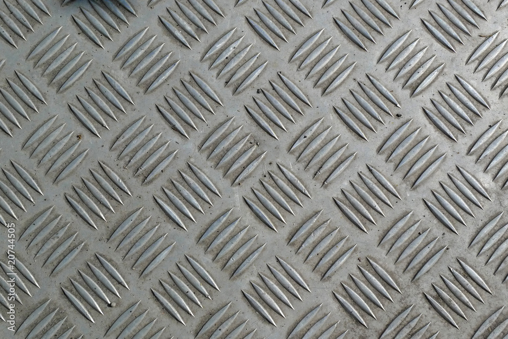 Detail of a grid of steel placed along a road Detail of a grid of steel placed along a road