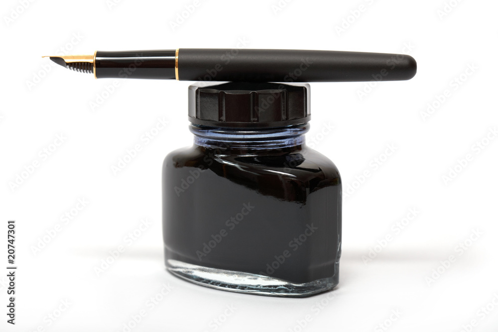 fountain pen lying on the ink bottle