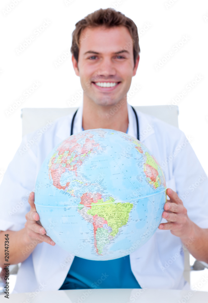 Portrait of a smiling male doctor holding a terrestrial globe Portrait of a smiling male doctor holding a terrestrial globe