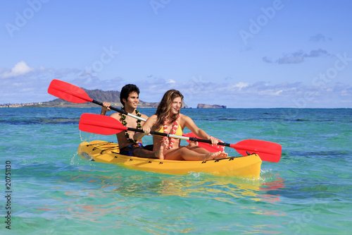 young couple with a kayak in hawaii
