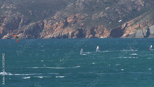 Kitesurfers in action on beach