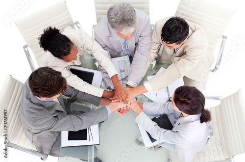 Cheerful international business people with hands together