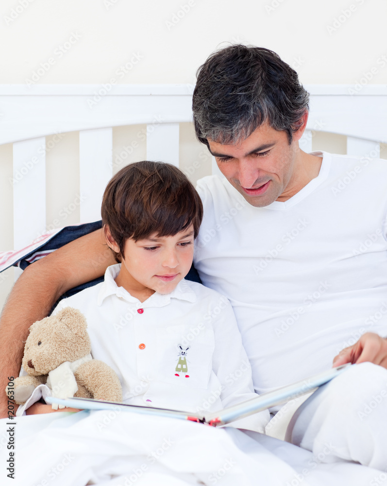Caring father reading with his son Caring father reading with his son