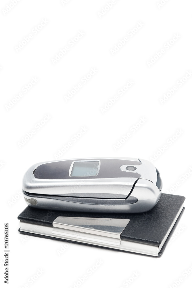 Folded mobile phone on business card holder on white Folded mobile phone on business card holder on white