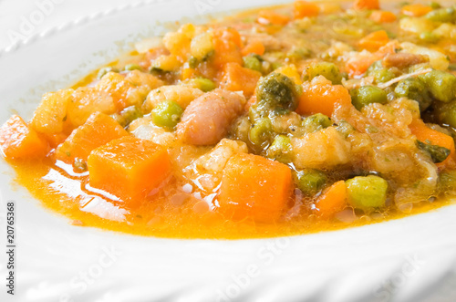 Vegetable soup on white dish.
