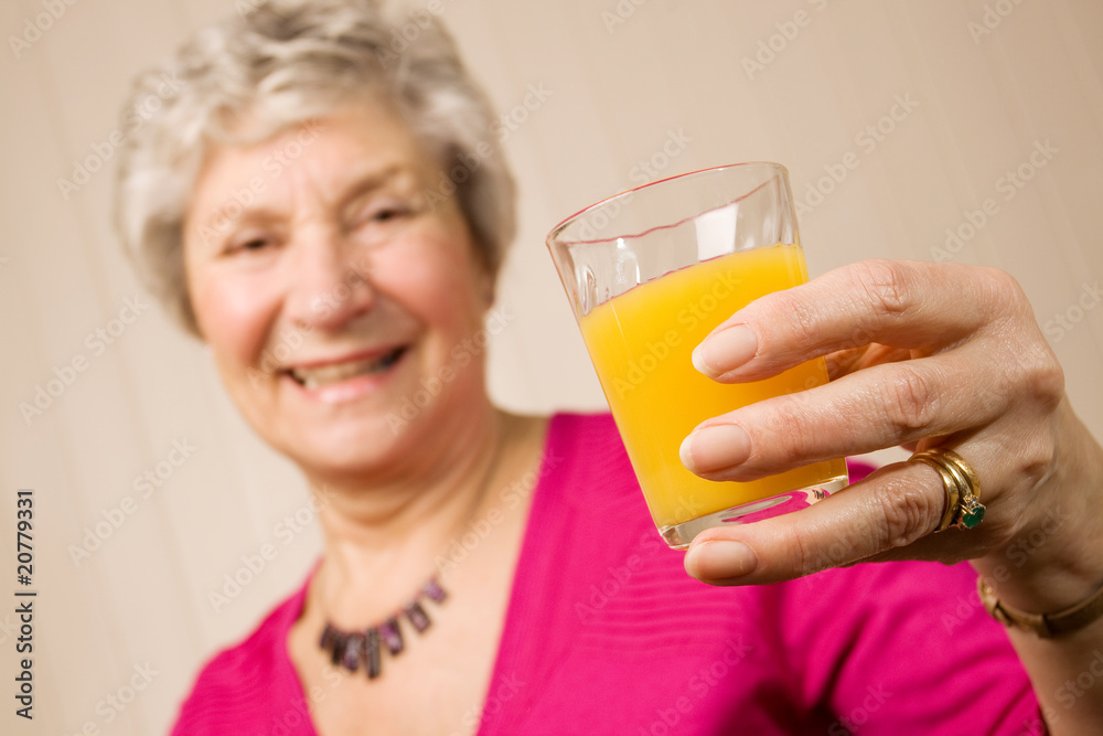 Senior older lady with glass of orange juice Senior older lady with glass of orange juice