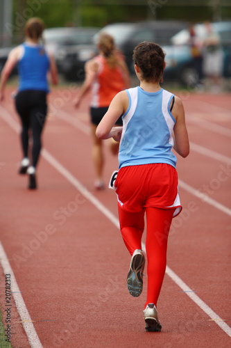 Female athletes running on the track