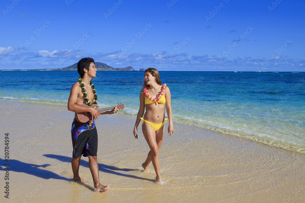 pacific island man plays his ukulele for a young woman