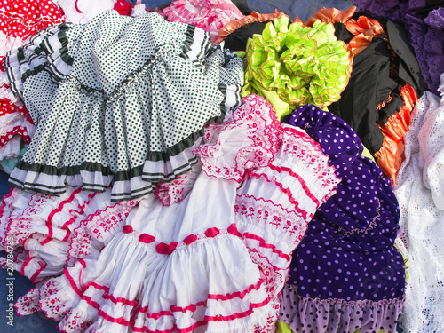 Gitana selling used clothes at flea market street of Malaga