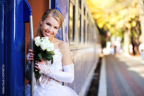 Beautiful young bride on a train