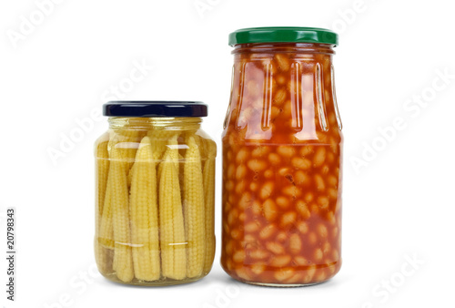 Glass jars with marinated corn ears and harricot beans