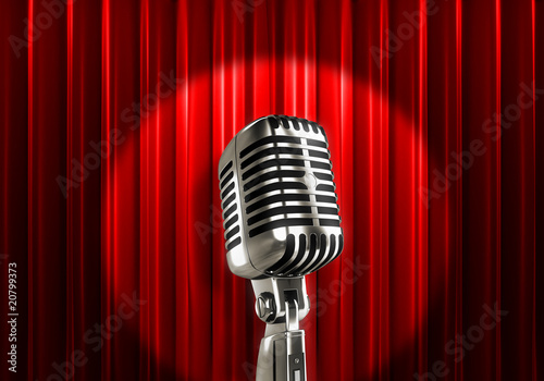Silver microphone with red curtains