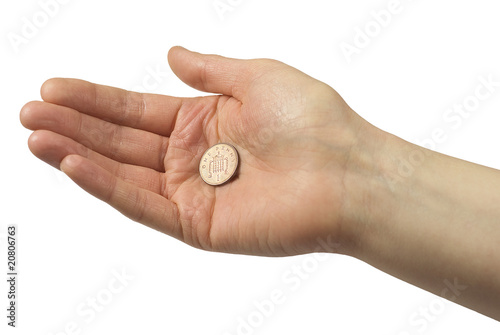 Hand holding one pence piece