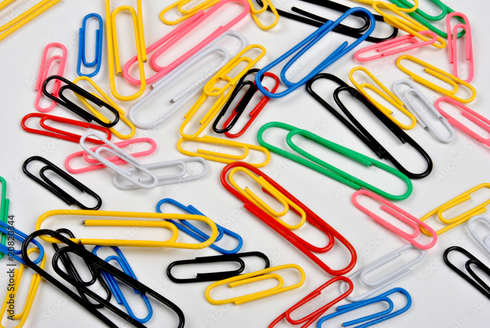 some coloured paper clips and a white background some coloured paper clips and a white background