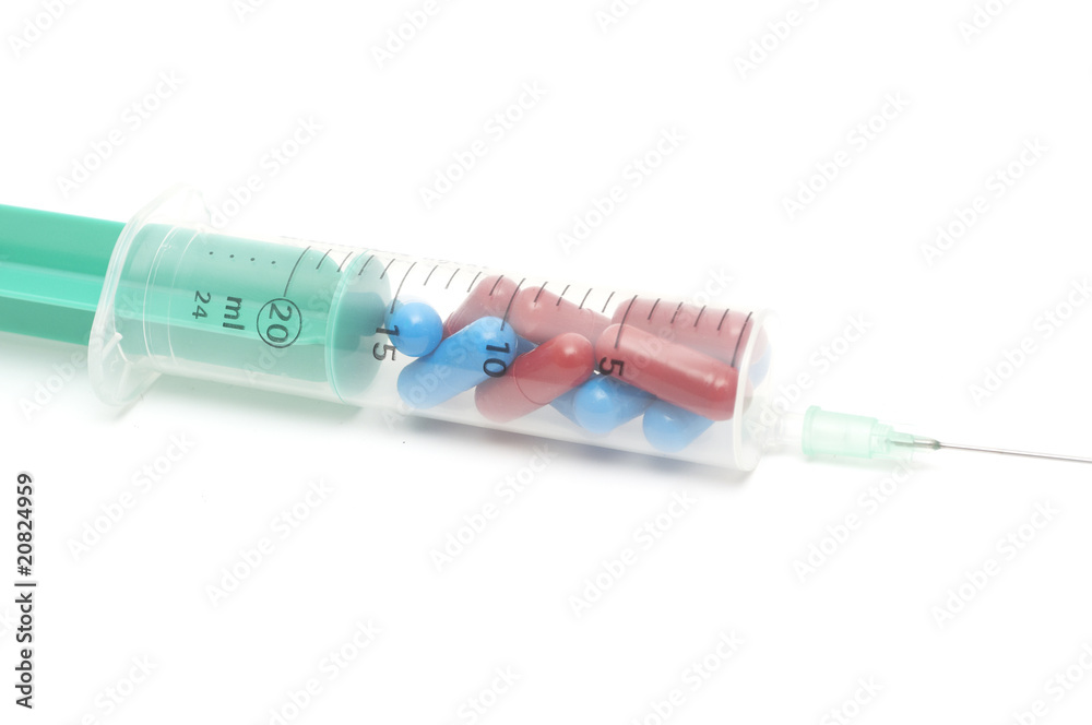 Syringe and pills isolated on a white background Syringe and pills isolated on a white background