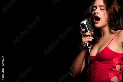 Beautiful singer singing with microphone
