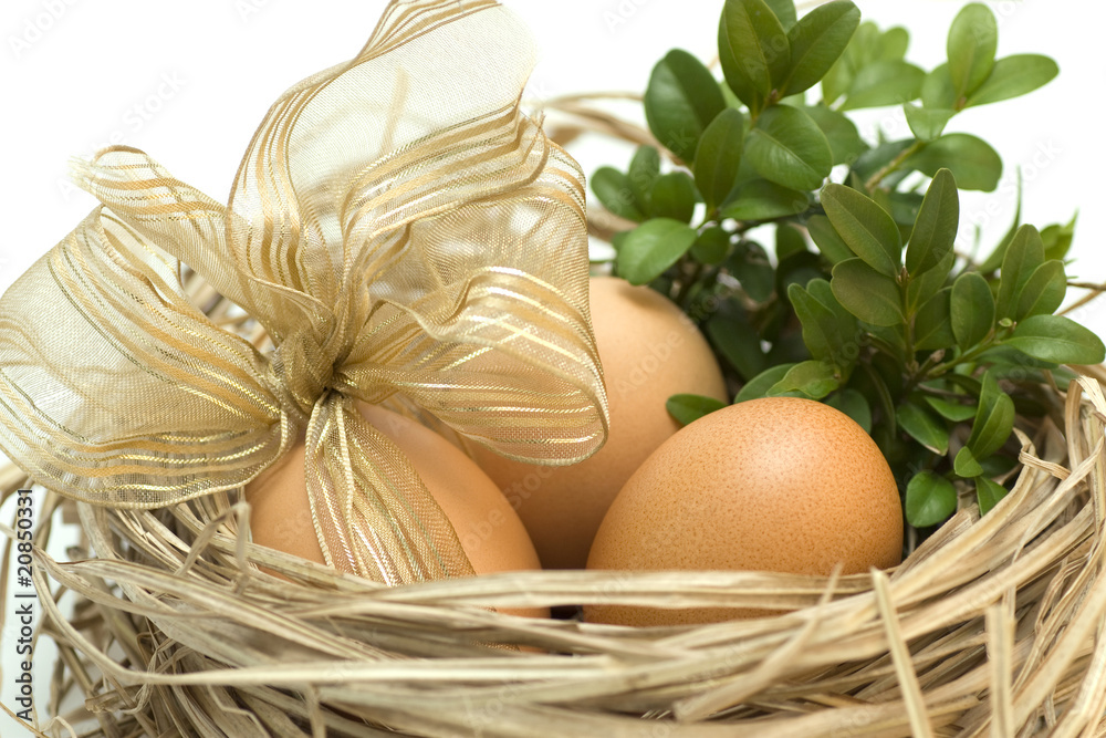 Three easter eggs in straw