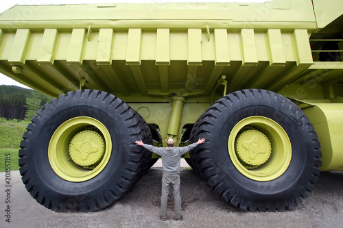 Earth moving dump truck with a man at the wheel photo