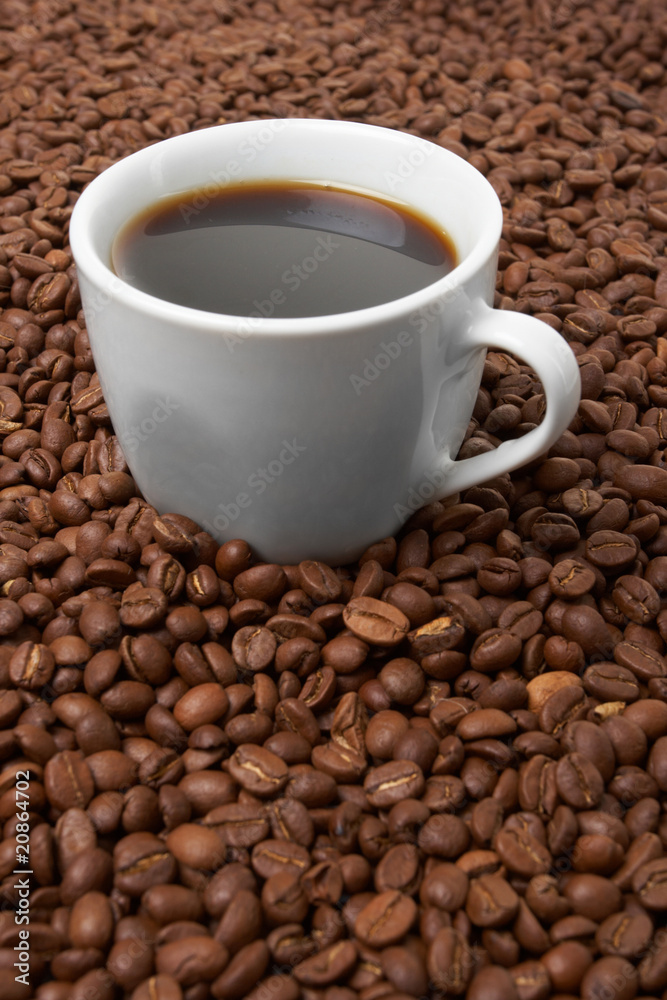 Cup with coffee, costing on coffee grain Cup with coffee, costing on coffee grain