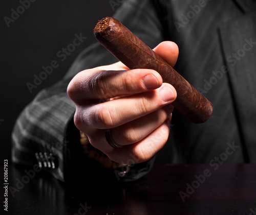 Hand holding cigar