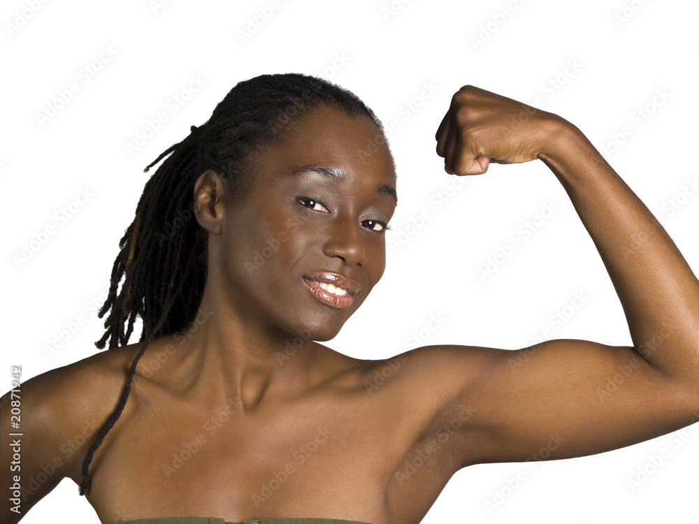 Young black woman showing her bicep muscle Young black woman showing her bicep muscle