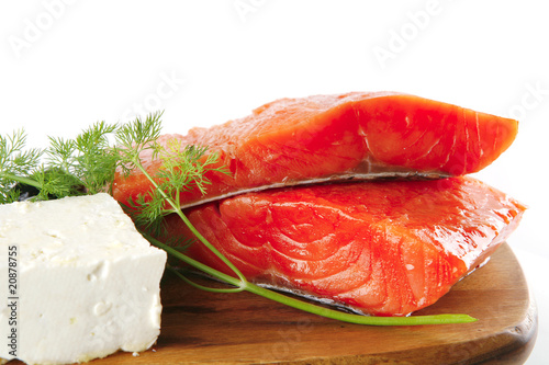 pink salmon on wooden plate with cheese