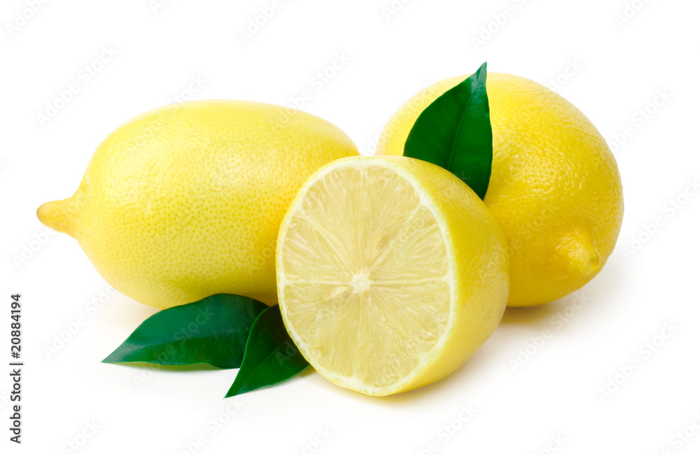 Three ripe lemons with sheet on white background
