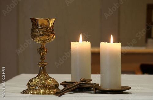 Golden chalice and two burning candles