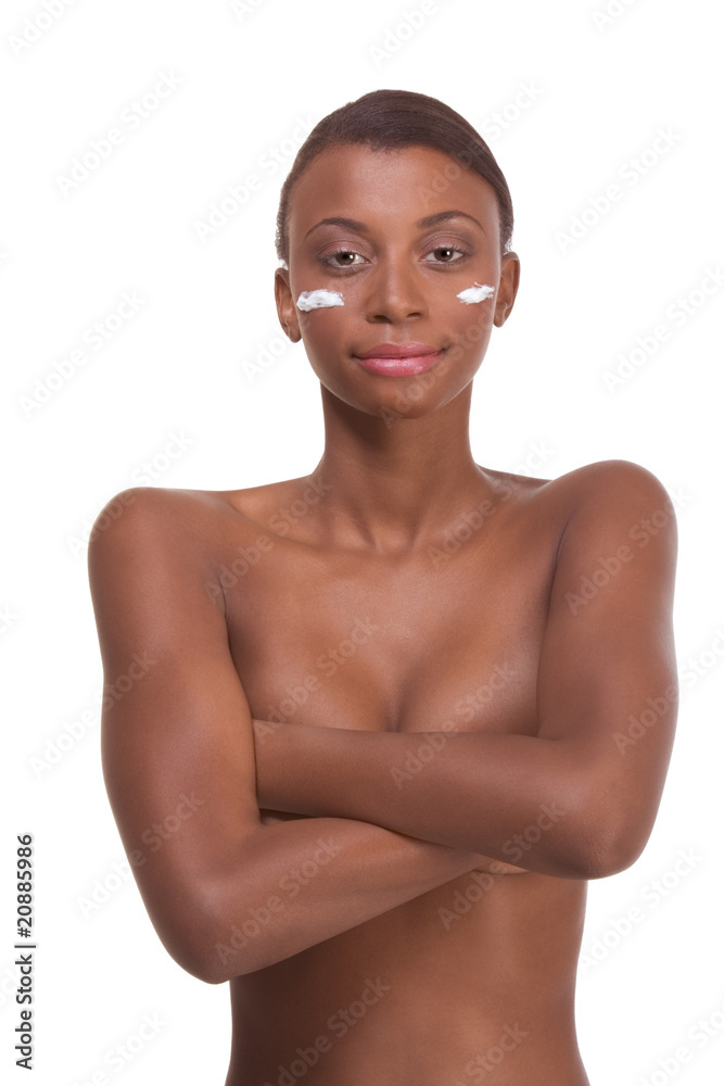 Topless ethnic Black woman moisturizing face Topless ethnic Black woman moisturizing face