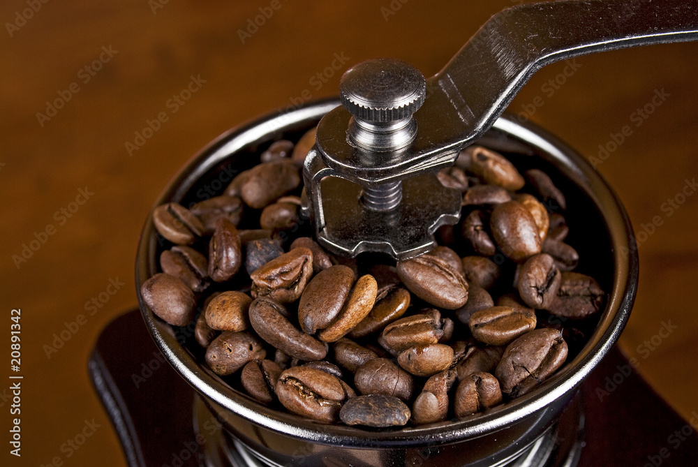 Fototapeta premium roasted coffee beans in a grinder