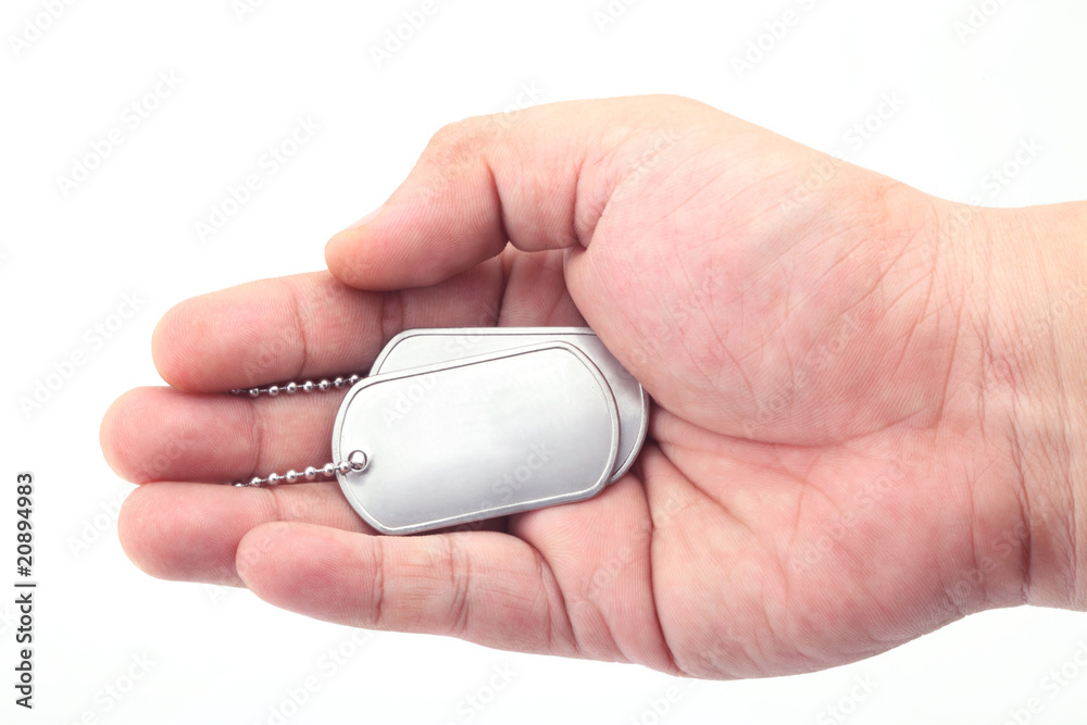 dog tag on the hand