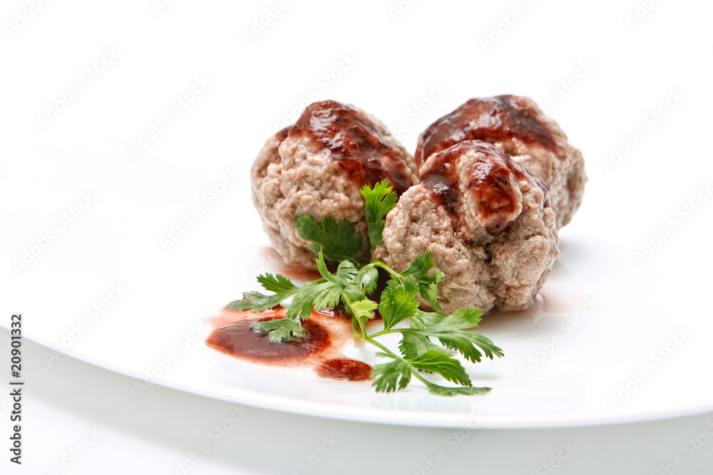 Boiled meatballs with gravy and parsley on white background Boiled meatballs with gravy and parsley on white background