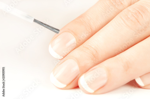 Manicurist applying natural looking nail polish