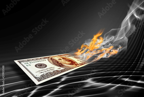 burning one hundred dollars banknote photo