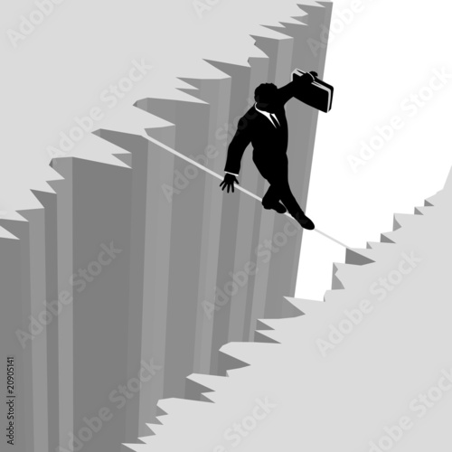 Business man walks risk tightrope over cliff drop danger