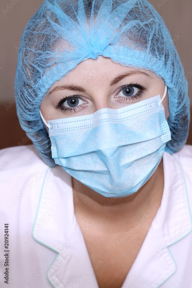 Closeup portrait of a young doctor wearing a mask Closeup portrait of a young doctor wearing a mask
