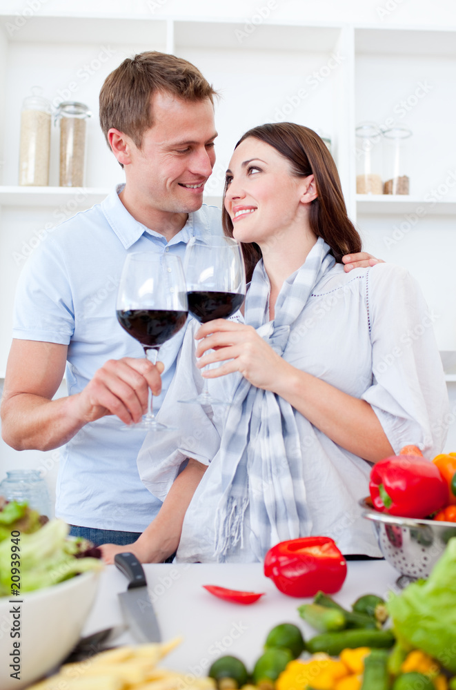 Affectionate couple drinking wine while cooking