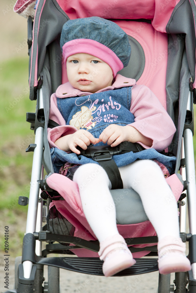 toddler sitting in a pram on walk toddler sitting in a pram on walk