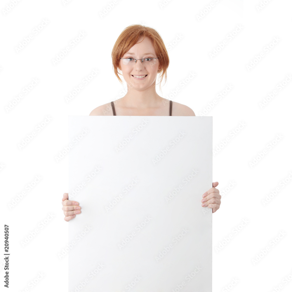 Young redhead woman with blank board