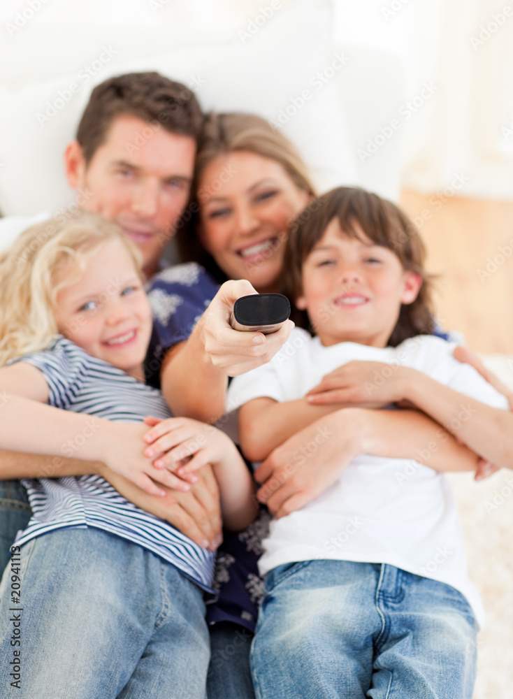 United family watching television sitting on sofa United family watching television sitting on sofa